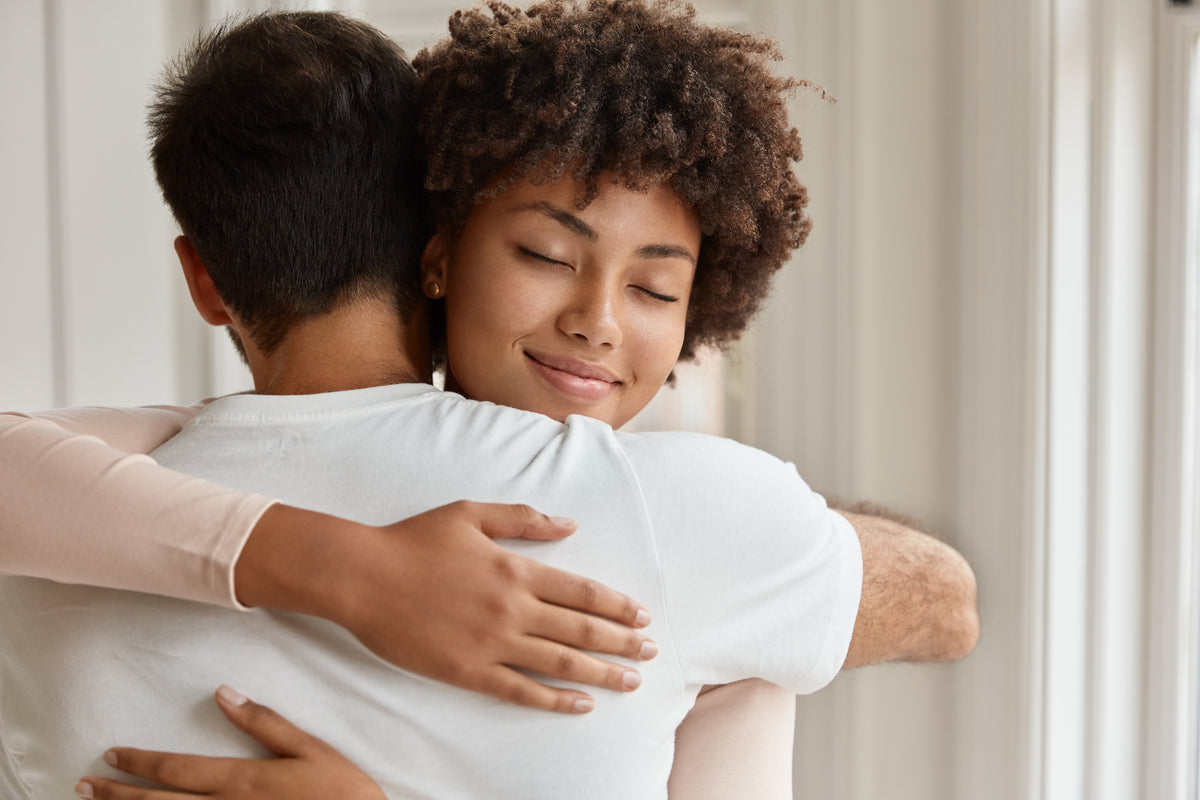 Mixed race couple warm hug