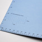 Scribe blue inner cover with ruler guidelines and dot grid dimensions layout