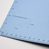 Scribe blue inner cover with ruler guidelines and dot grid dimensions layout